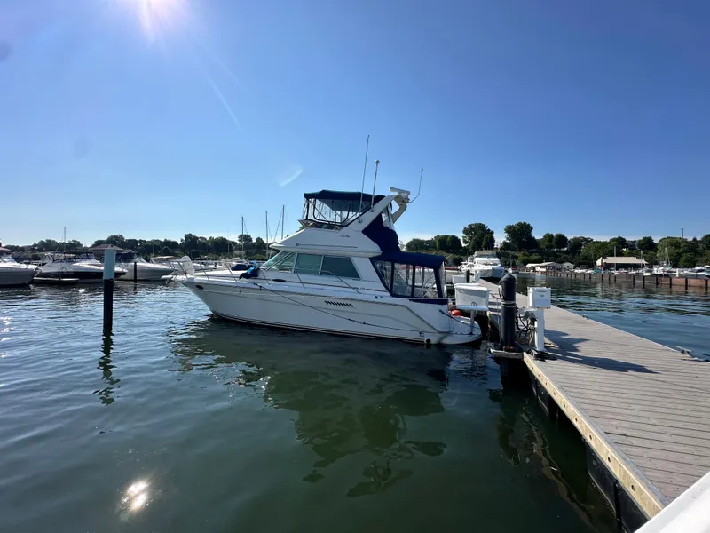 Slide: The Image of 1996 Sea Ray 370 Sedan Bridge docked at a marina on a sunny day. - 21