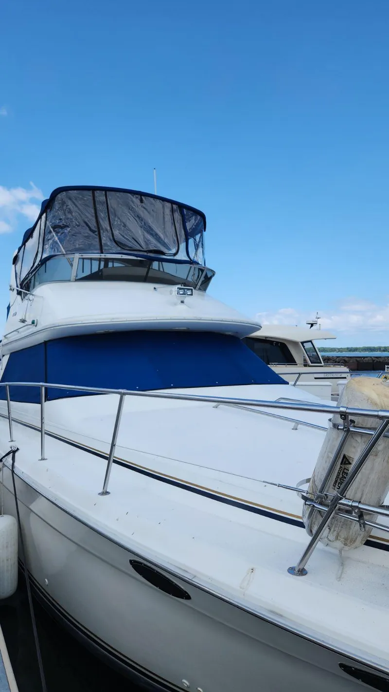 Slide: The Image of 1996 Sea Ray 370 Sedan Bridge yacht docked at marina. - 3