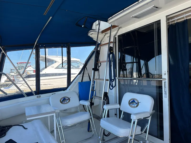 Slide: The Image of Interior of 1996 Sea Ray 370 Sedan Bridge with seating and ladder. - 35