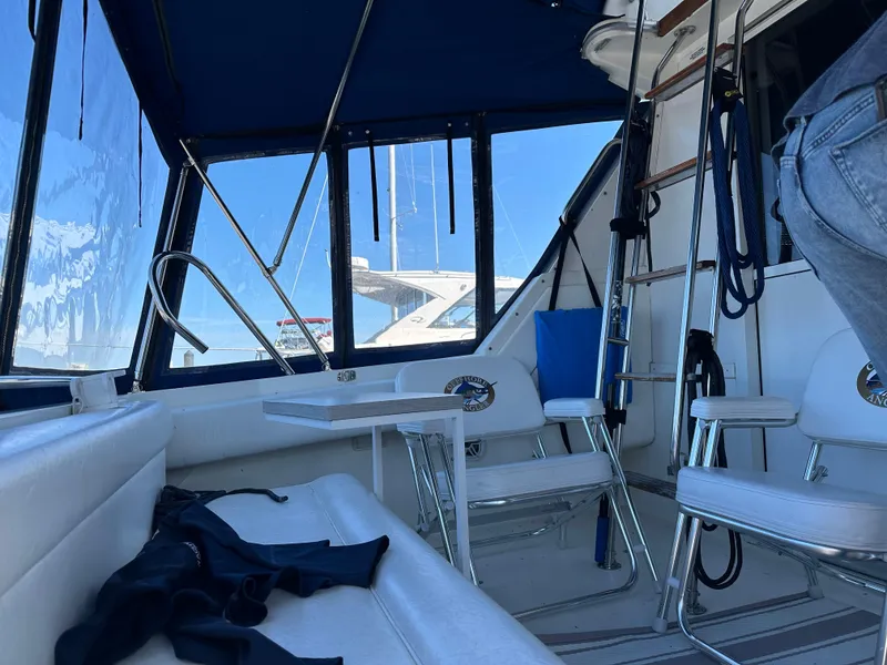 Slide: The Image of Interior view of 1996 Sea Ray 370 Sedan Bridge yacht with seating and table. - 42