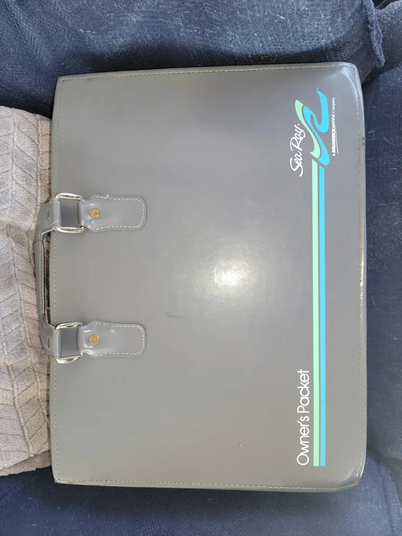 Slide: The Image of 1996 Sea Ray 370 Sedan Bridge owner's packet in a gray binder. - 49