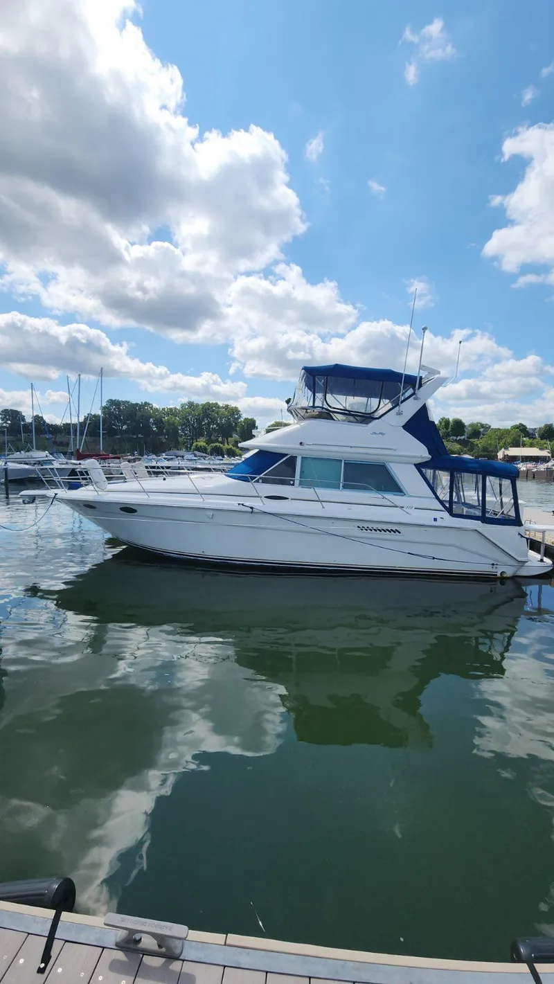 Slide: The Image of 1996 Sea Ray 370 Sedan Bridge yacht docked at a marina on a sunny day. - 5