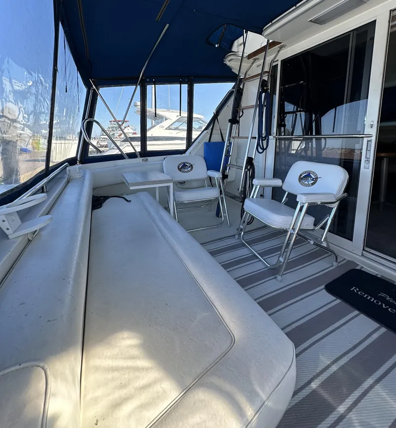 Slide: The Image of 1996 Sea Ray 370 Sedan Bridge interior with seating and striped flooring. - 6
