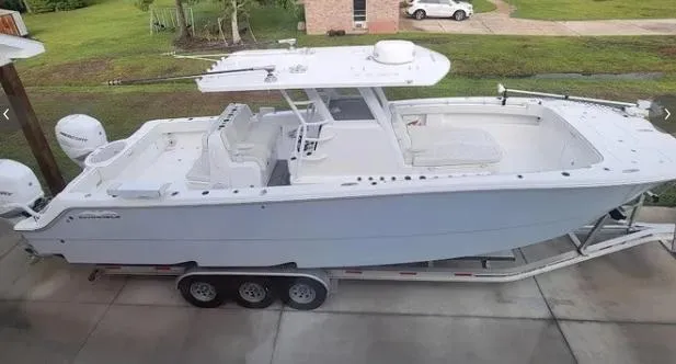 Slide: The Image of 2022 Invincible 33 Catamaran on a trailer in a driveway. - 3