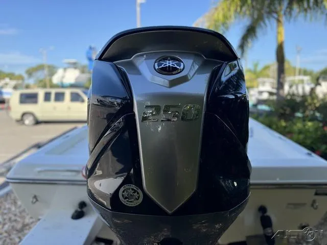 Slide: The Image of 2024 Skeeter SX230 boat with a powerful 250 HP engine, parked outdoors. - 15