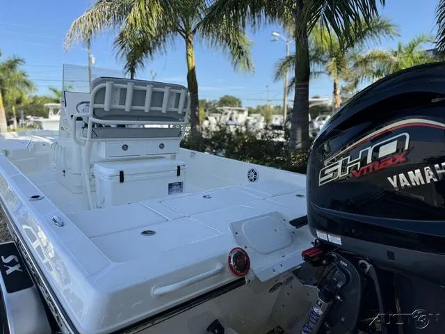 Slide: The Image of 2024 Skeeter SX230 boat with Yamaha SHO VMAX engine, docked near palm trees. - 16