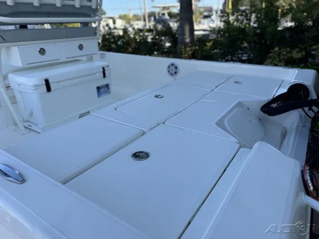 Slide: The Image of 2024 Skeeter SX230 boat deck with storage compartments and cooler. - 18