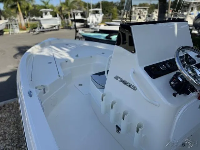 Slide: The Image of 2024 Skeeter SX230 boat interior with steering console and rod holders. - 23