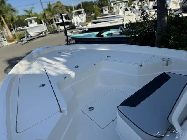 Slide: The Image of 2024 Skeeter SX230 boat deck with storage compartments and seating. - 26