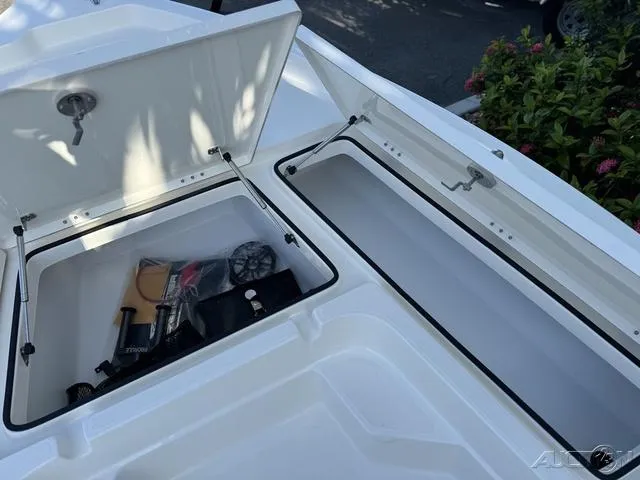 Slide: The Image of 2024 Skeeter SX230 boat storage compartments with gear and accessories. - 32
