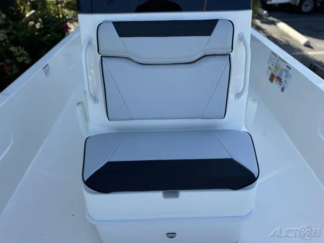 Slide: The Image of 2024 Skeeter SX230 boat seating with white and black upholstery. - 33