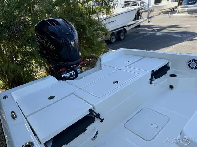 Slide: The Image of 2024 Skeeter SX230 boat with outboard motor and storage compartments. - 36