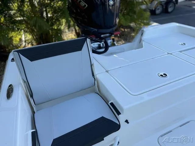 Slide: The Image of 2024 Skeeter SX230 boat with cushioned seating and storage compartments. - 37