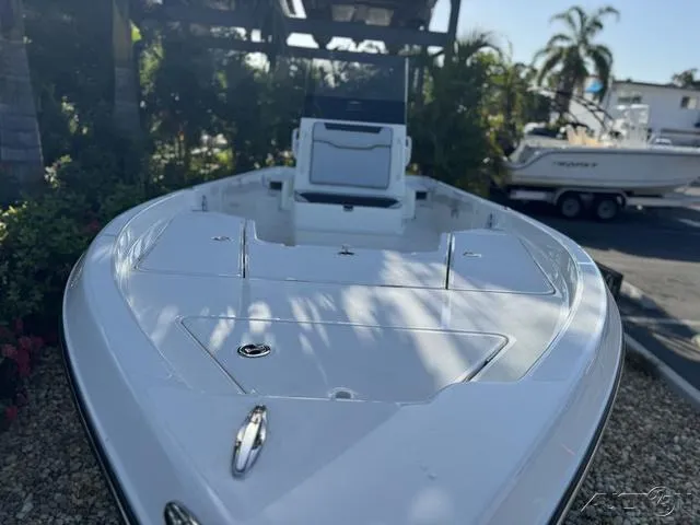 Slide: The Image of 2024 Skeeter SX230 boat with sleek white deck and seating area. - 6