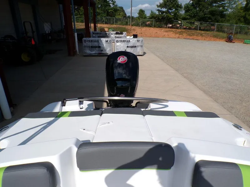 Slide: The Image of 2024 Tahoe T18 boat rear view with outboard motor in a sunny outdoor setting. - 11