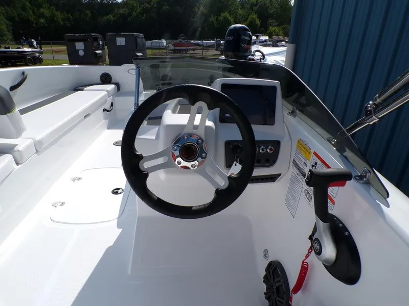 Slide: The Image of 2024 Tahoe T18 boat cockpit with steering wheel and control panel. - 14