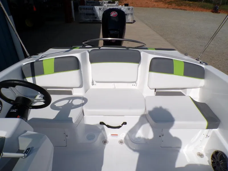 Slide: The Image of 2024 Tahoe T18 boat interior with white and gray seating, green accents, and steering wheel. - 17