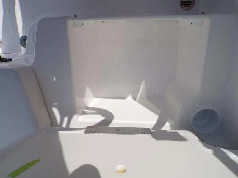 Slide: The Image of 2024 Tahoe T18 boat interior storage compartment, white and spacious design. - 18