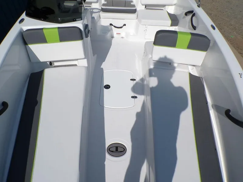 Slide: The Image of 2024 Tahoe T18 boat interior with gray and green seating, shadow visible. - 20