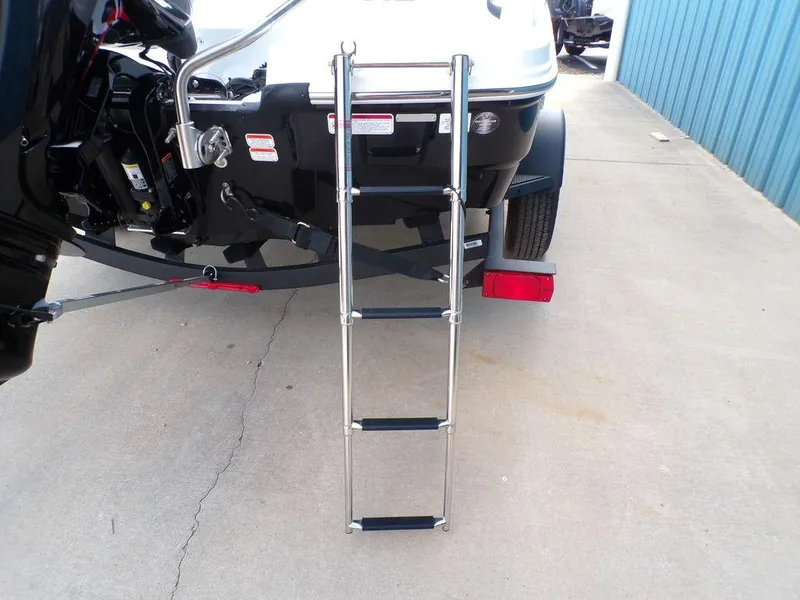 Slide: The Image of 2024 Tahoe T18 boat with a rear boarding ladder on a concrete surface. - 23