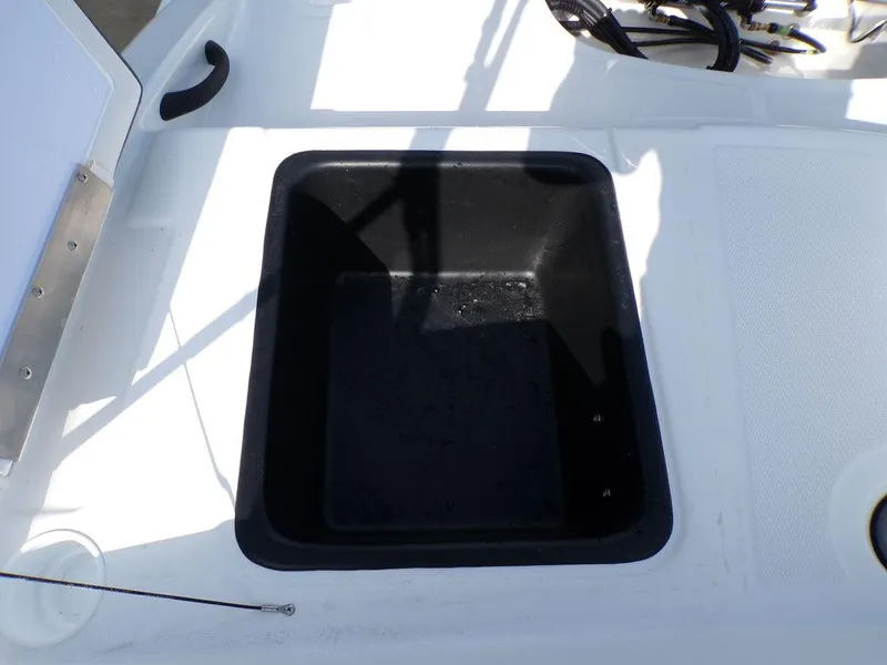 Slide: The Image of 2024 Tahoe T18 boat storage compartment, black interior, white exterior. - 24