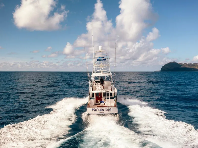 Slide: The Image of 1997 Buddy Davis Sportfisher Convertible cruising on open ocean under blue sky. - 14
