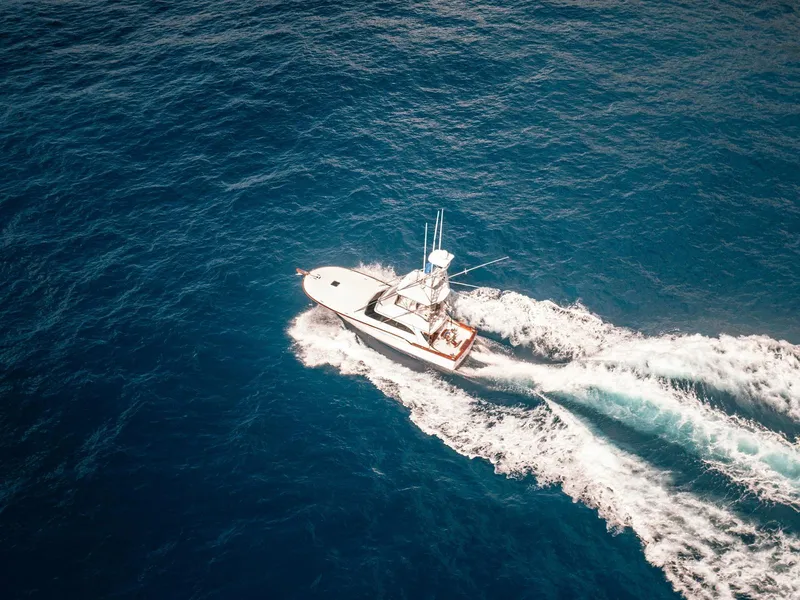 Slide: The Image of Aerial view of 1997 Buddy Davis Sportfisher Convertible cruising on open ocean waters. - 15