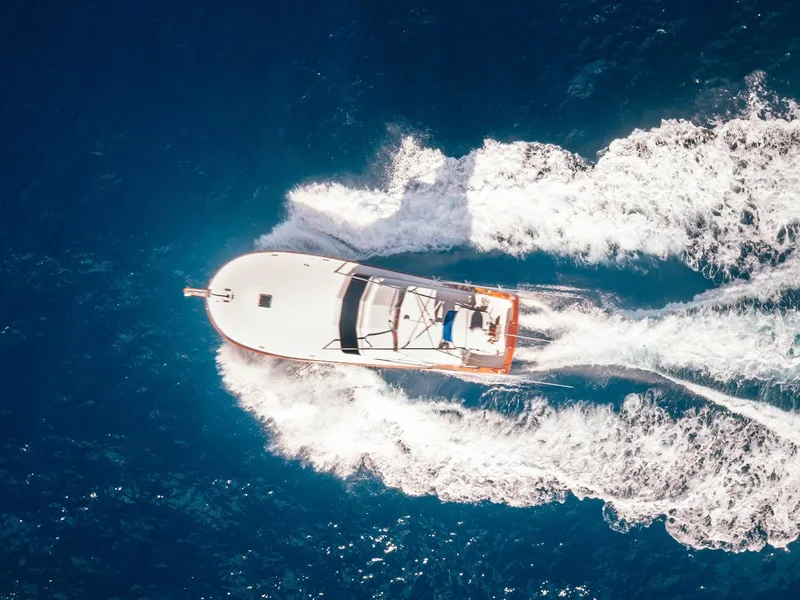 Slide: The Image of Aerial view of 1997 Buddy Davis Sportfisher Convertible cruising on blue ocean waters. - 16