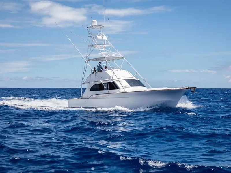 Slide: The Image of 1997 Buddy Davis Sportfisher Convertible cruising on open ocean under clear blue sky. - 19