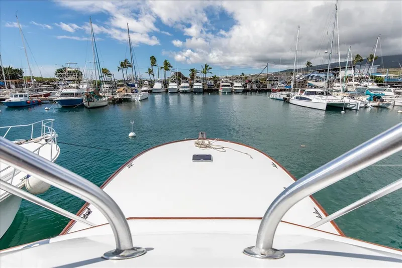 Slide: The Image of 1997 Buddy Davis Sportfisher Convertible in a marina, surrounded by boats and palm trees. - 29