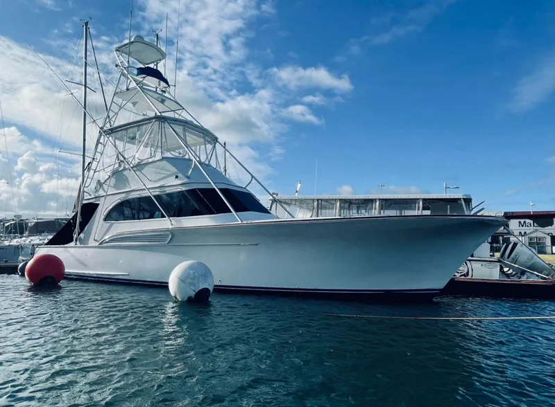 Slide: The Image of 1997 Buddy Davis Sportfisher Convertible yacht docked in marina under blue sky. - 3