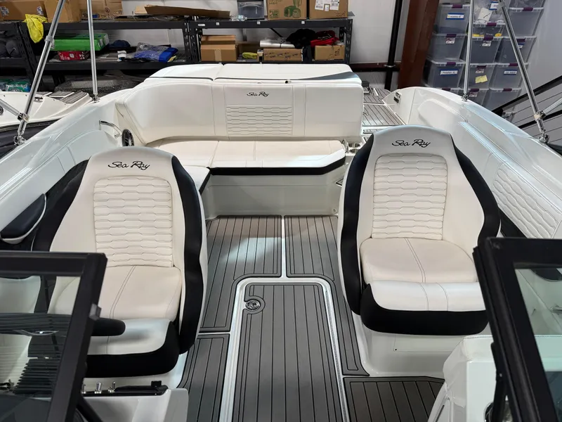 Slide: The Image of 2023 Sea Ray SPX 210 boat interior with white seating and sleek design. - 10