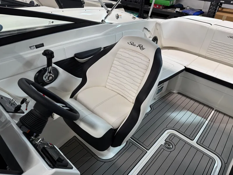 Slide: The Image of 2023 Sea Ray SPX 210 boat interior with steering wheel and seating. - 11