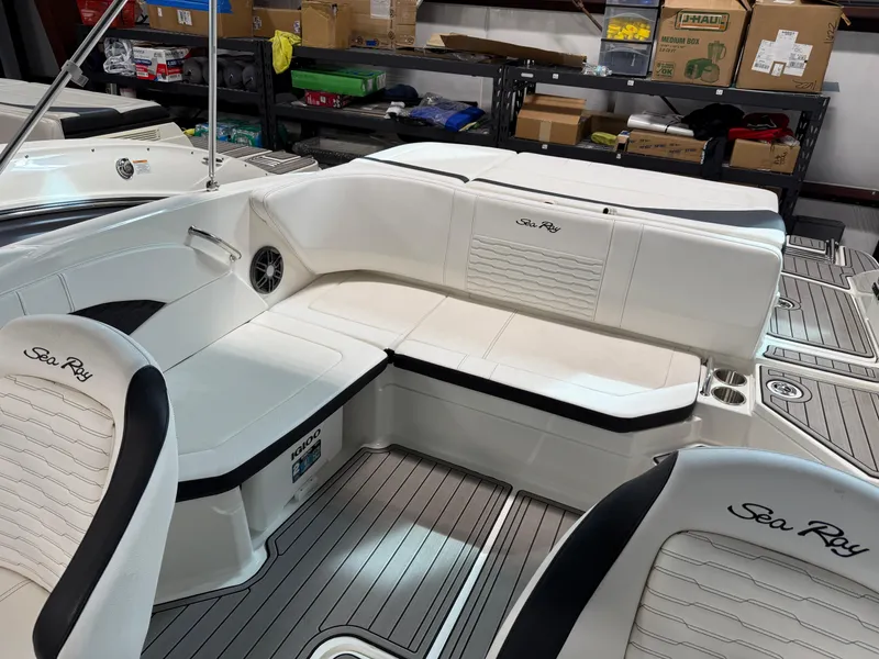 Slide: The Image of 2023 Sea Ray SPX 210 boat interior with white seating and sleek design. - 12