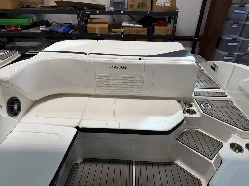 Slide: The Image of 2023 Sea Ray SPX 210 boat interior with white seating and modern design. - 13