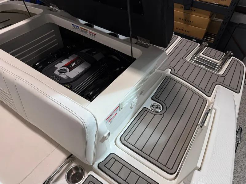 Slide: The Image of 2023 Sea Ray SPX 210 boat engine compartment with open hatch, showcasing modern design. - 16