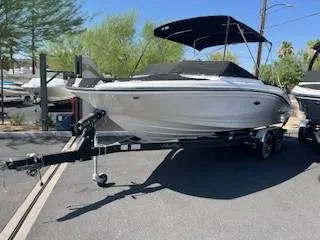 Slide: The Image of 2023 Sea Ray SPX 210 boat on a trailer with a black canopy. - 17