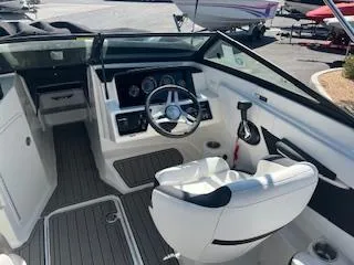 Slide: The Image of 2023 Sea Ray SPX 210 boat interior with steering wheel and captain's chair. - 20