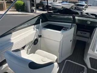 Slide: The Image of 2023 Sea Ray SPX 210 boat interior with white seating and dashboard. - 21