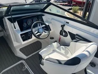 Slide: The Image of 2023 Sea Ray SPX 210 boat cockpit with steering wheel and control panel. - 22