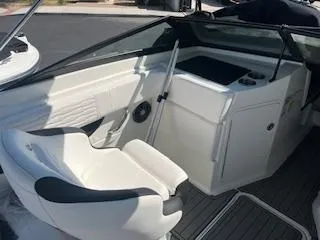 Slide: The Image of 2023 Sea Ray SPX 210 boat interior with white seating and dashboard. - 23
