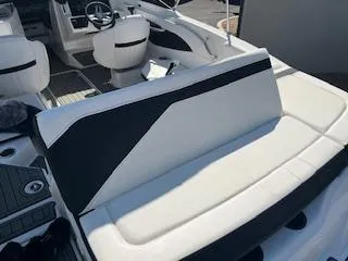 Slide: The Image of 2023 Sea Ray SPX 210 boat interior with white and black seating. - 25