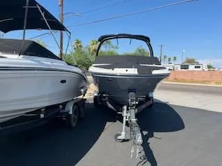 Slide: The Image of 2023 Sea Ray SPX 210 boat on a trailer, parked outdoors. - 27