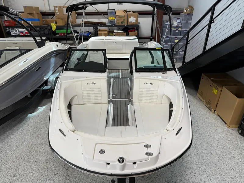Slide: The Image of 2023 Sea Ray SPX 210 boat with sleek design in showroom setting. - 5