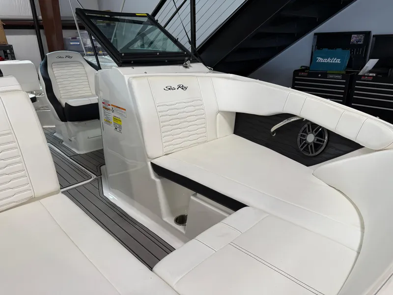 Slide: The Image of 2023 Sea Ray SPX 210 boat interior with white seating and modern design. - 8