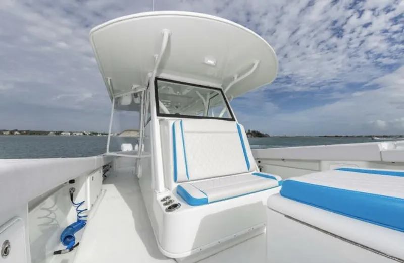 Slide: The Image of 2018 Yellowfin 39 boat with white and blue seating on a sunny day. - 12