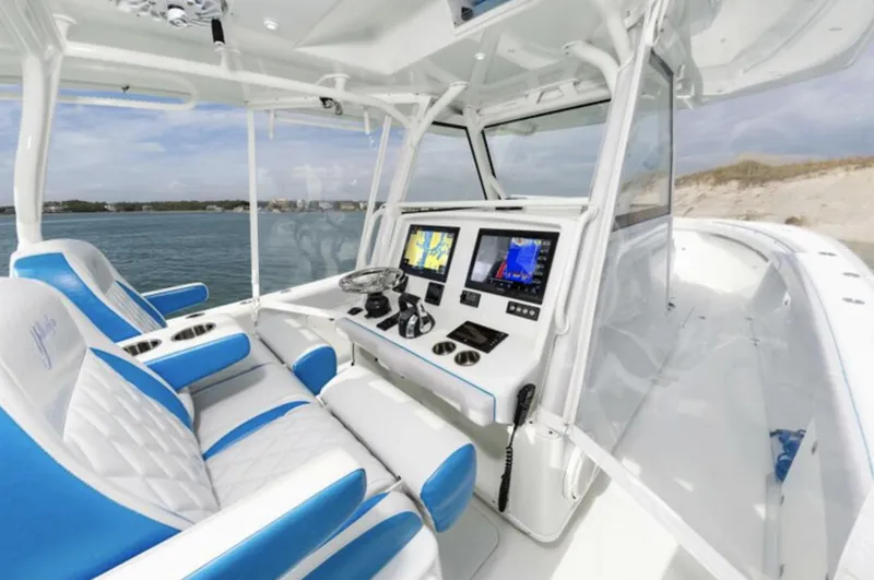 Slide: The Image of 2018 Yellowfin 39 boat cockpit with dual screens and blue-white seating. - 15