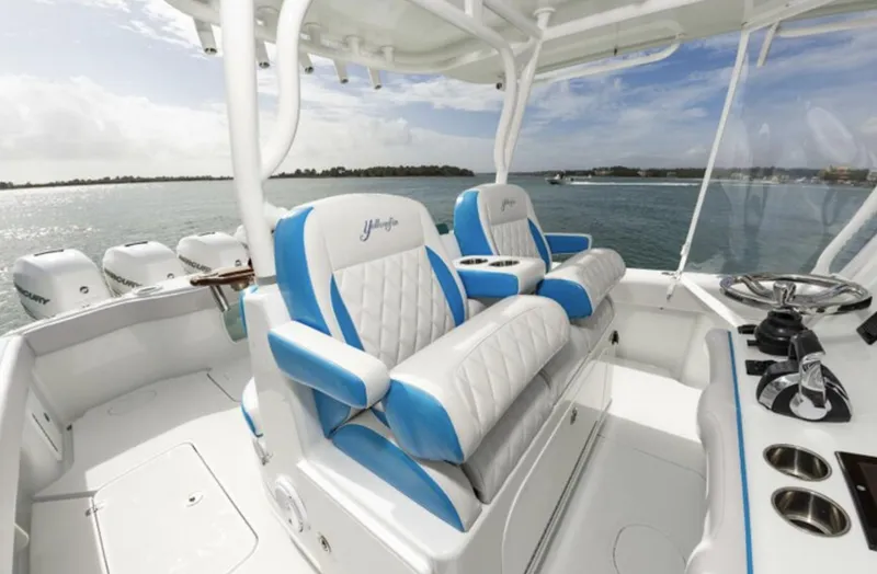 Slide: The Image of 2018 Yellowfin 39 boat interior with blue and white seating, ocean view in background. - 16