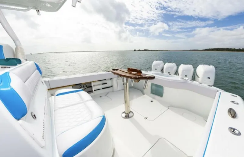 Slide: The Image of 2018 Yellowfin 39 boat interior with white and blue seating, ocean view. - 18