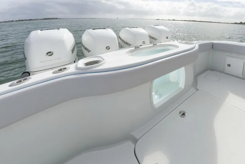 Slide: The Image of 2018 Yellowfin 39 boat with multiple outboard engines on calm water. - 19